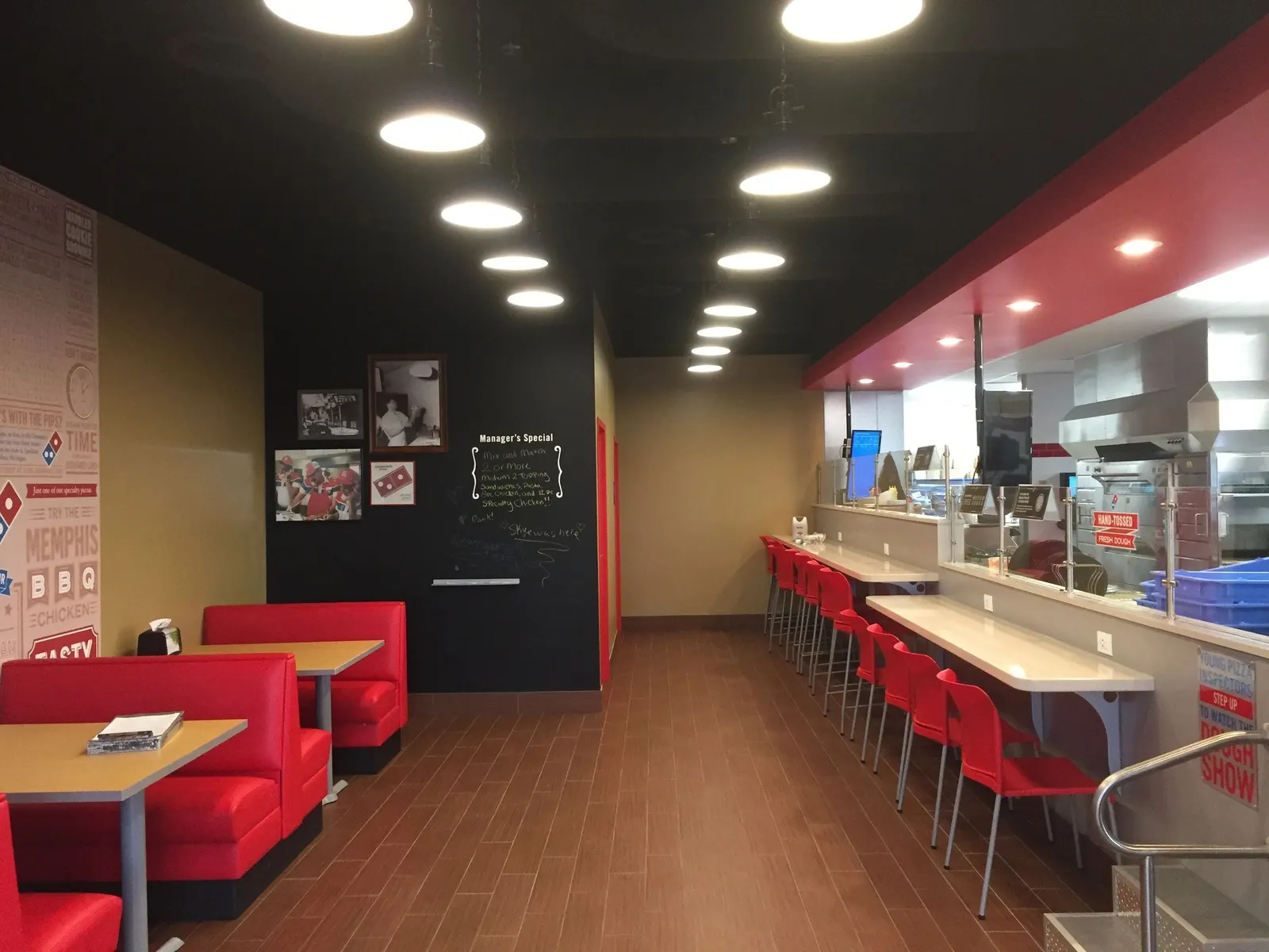 Restaurant dining area with red and cream walls and a dark ceiling